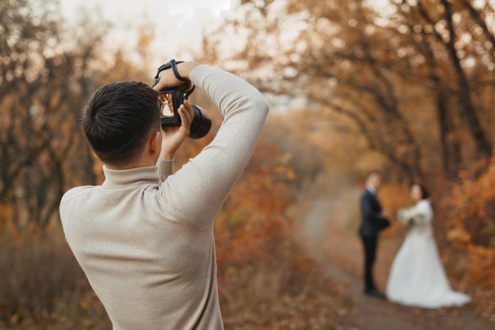 Professional,Wedding,Photographer,Taking,Pictures,Of,The,Bride,And,Groom